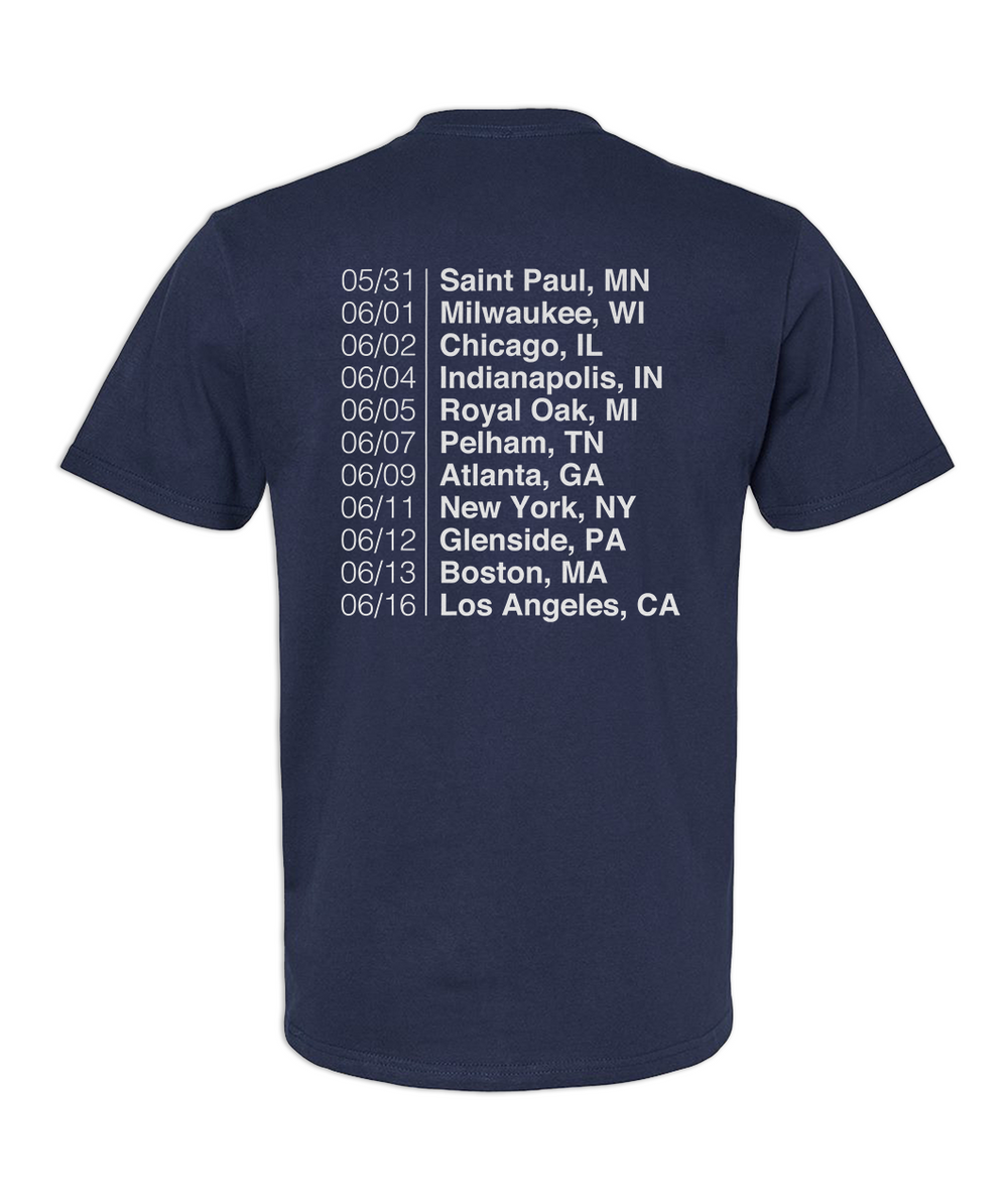 Back of a short sleeve Navy t-shirt that has the tour dates for The Areas Tour printed in white ink in the center back of the shirt. "05/31 | Saint Paul, MN, 06/01 | Milwaukee, WI, 06/02 | Chicago, IL, 06/04 | Indianapolis, IN, 06/05 | Royal Oak, MI, 06/07 | Pelham, TN, 06/09 | Atlanta, GA, 06/11 | New York, NY, 06/12 | Glenside, PA, 06/13 | Boston, MA, 06/16 | Los Angeles, CA."